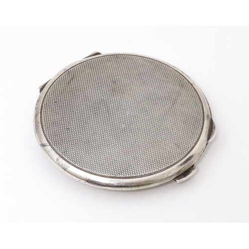 475 - A Silver compact with engine turned decoration. Hallmarked Birmingham 1965 maker Garrard & Co Ltd. A... 