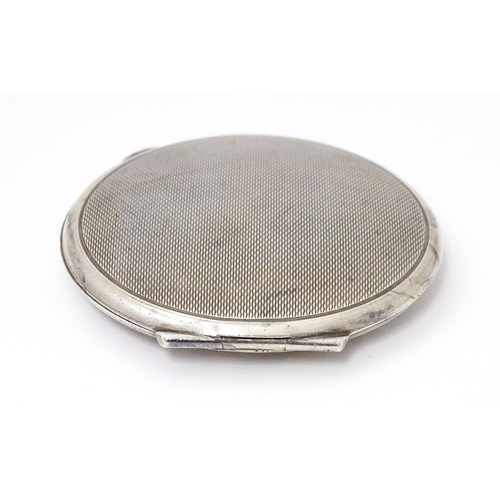 475 - A Silver compact with engine turned decoration. Hallmarked Birmingham 1965 maker Garrard & Co Ltd. A... 