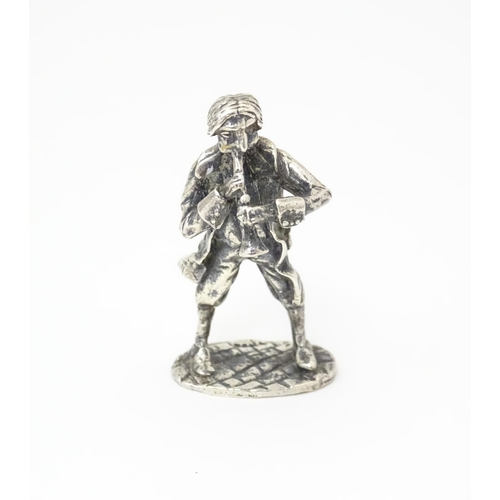 478 - A silver model of musician plying an instrument. Hallmarked  London 1978 maker SMO. 2