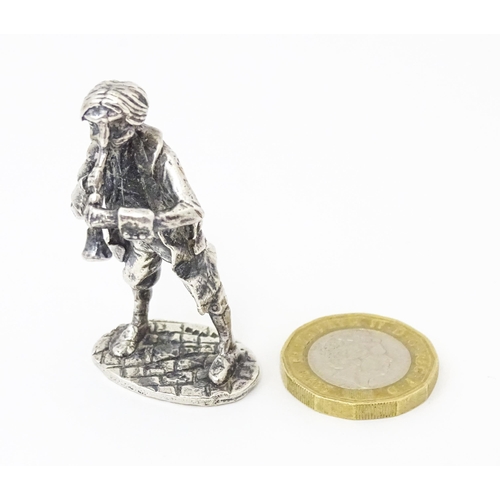 478 - A silver model of musician plying an instrument. Hallmarked  London 1978 maker SMO. 2