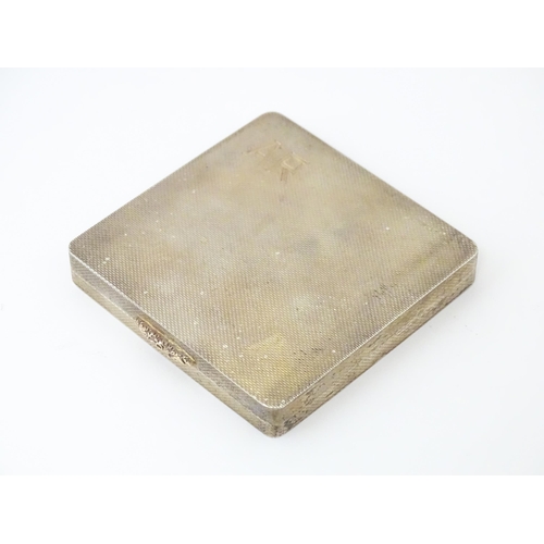 481 - A silver compact of squared form with engine turned decoration and gilded interior. Hallmarked Londo... 