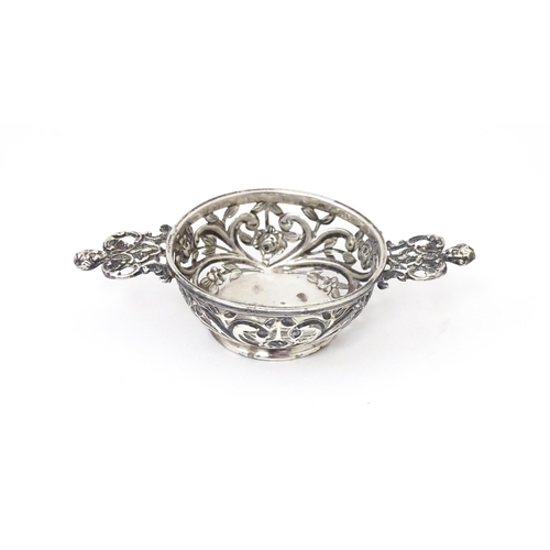 482 - A Victorian silver two handled dish / quaich with pierced and embossed decoration. Hallmarked London... 