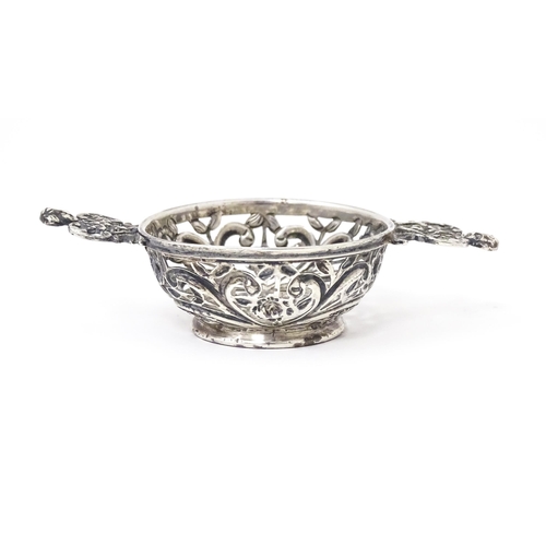 482 - A Victorian silver two handled dish / quaich with pierced and embossed decoration. Hallmarked London... 