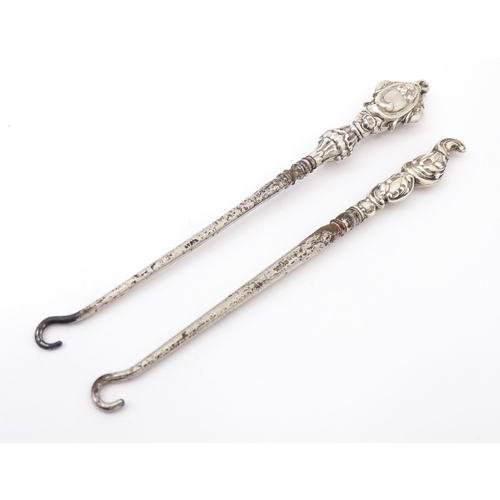 492 - Two silver handled button hooks. One hallmarked Birmingham 1901 maker William Devenport. Approx 6 1/... 