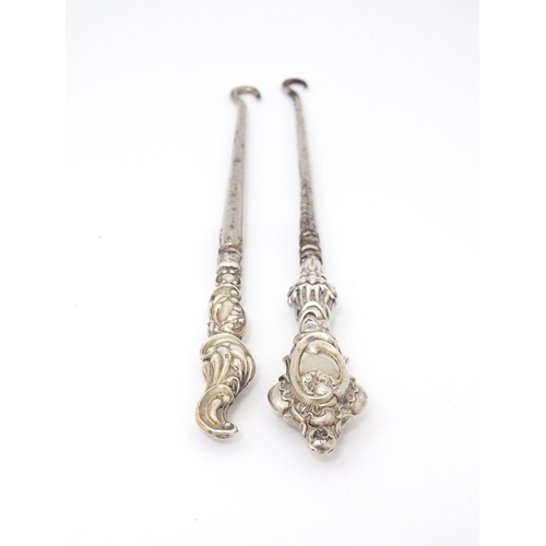 492 - Two silver handled button hooks. One hallmarked Birmingham 1901 maker William Devenport. Approx 6 1/... 