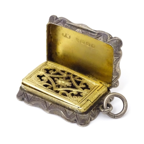 501 - A Victorian silver vinaigrette, the hinged lid opening to reveal hinged grill and gilded interior, h... 