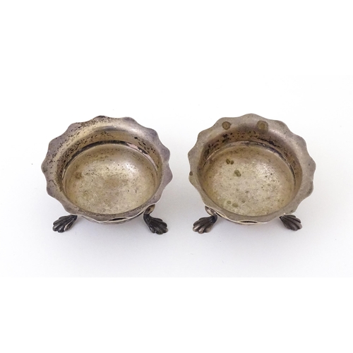 506 - A pair of silver salts raised on three feet. Hallmarked Birmingham 1904 maker F & D. Each approx. 1 ... 