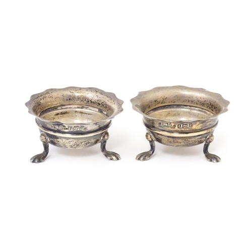 506 - A pair of silver salts raised on three feet. Hallmarked Birmingham 1904 maker F & D. Each approx. 1 ... 