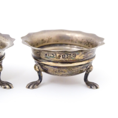 506 - A pair of silver salts raised on three feet. Hallmarked Birmingham 1904 maker F & D. Each approx. 1 ... 