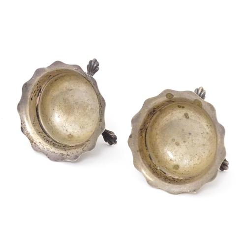 506 - A pair of silver salts raised on three feet. Hallmarked Birmingham 1904 maker F & D. Each approx. 1 ... 