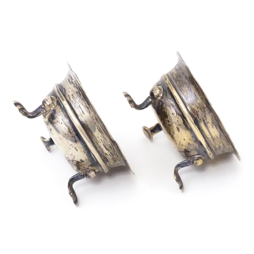 506 - A pair of silver salts raised on three feet. Hallmarked Birmingham 1904 maker F & D. Each approx. 1 ... 