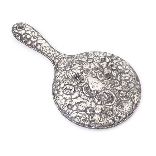 552 - A Victorian silver backed hand mirror with embossed floral and foliate decoration, hallmarked Birmin... 