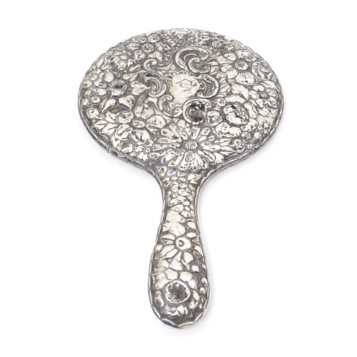 552 - A Victorian silver backed hand mirror with embossed floral and foliate decoration, hallmarked Birmin... 