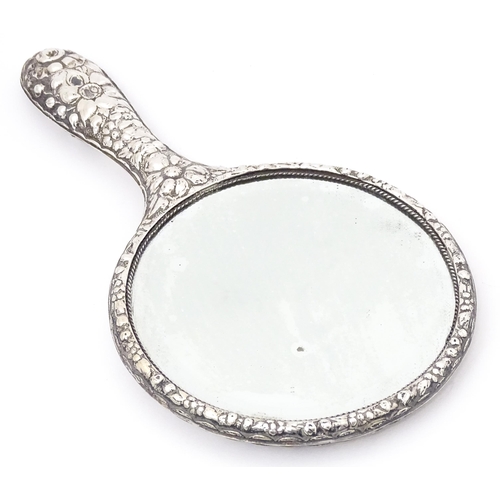 552 - A Victorian silver backed hand mirror with embossed floral and foliate decoration, hallmarked Birmin... 