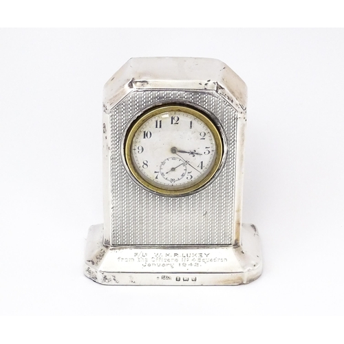 560 - WWII RAF interest : A silver cased mantle clock with engine turned decoration and inscription to ' F... 