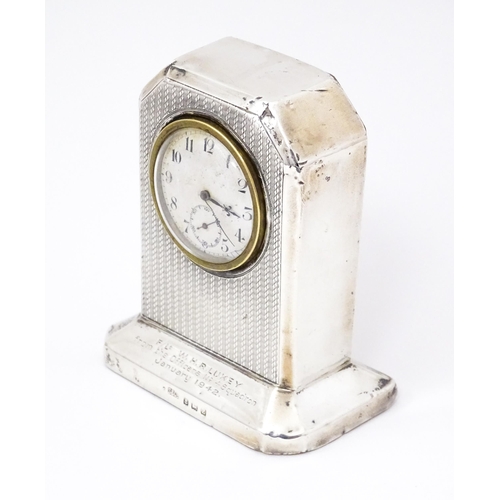 560 - WWII RAF interest : A silver cased mantle clock with engine turned decoration and inscription to ' F... 