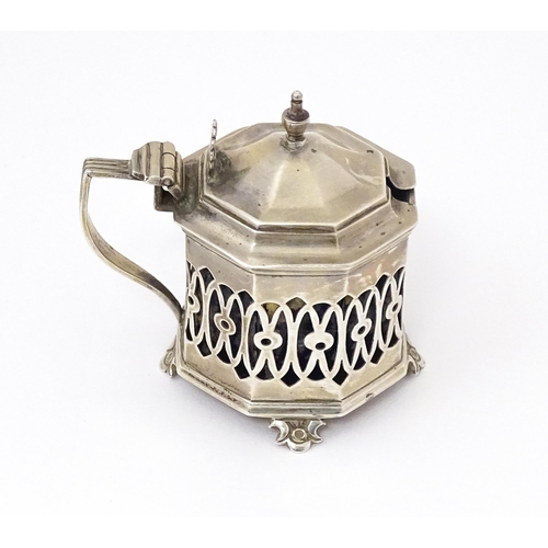 562 - A silver mustard pot with pierced decoration. Hallmarked Birmingham 1902 maker Robert Pringle & Sons... 