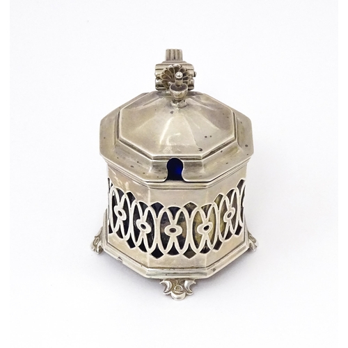 562 - A silver mustard pot with pierced decoration. Hallmarked Birmingham 1902 maker Robert Pringle & Sons... 