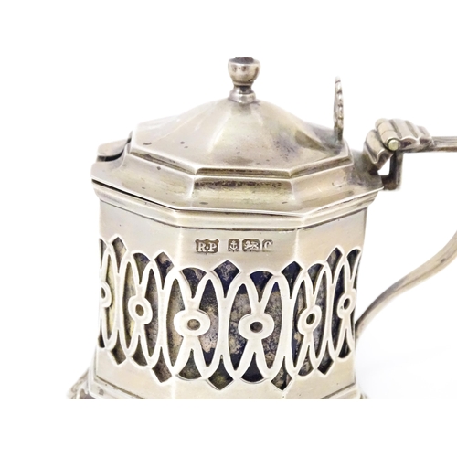 562 - A silver mustard pot with pierced decoration. Hallmarked Birmingham 1902 maker Robert Pringle & Sons... 