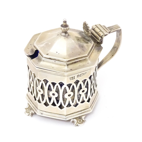 562 - A silver mustard pot with pierced decoration. Hallmarked Birmingham 1902 maker Robert Pringle & Sons... 