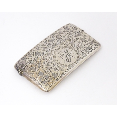 568 - A silver card case with engraved acanthus  scroll decoration. Hallmarked Birmingham 1920 maker Sydne... 