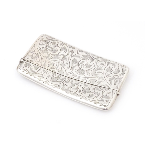 568 - A silver card case with engraved acanthus  scroll decoration. Hallmarked Birmingham 1920 maker Sydne... 