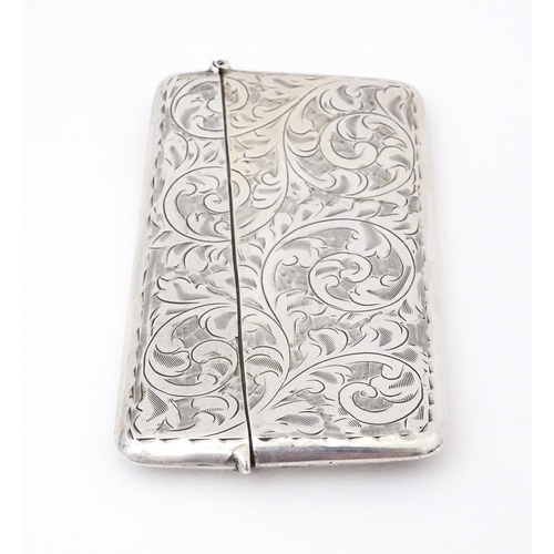 568 - A silver card case with engraved acanthus  scroll decoration. Hallmarked Birmingham 1920 maker Sydne... 