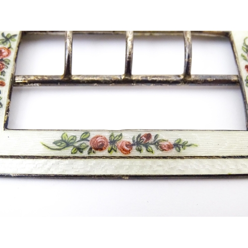 575 - A silver buckle with white guilloche enamel decoration and floral detail. Hallmarked Birmingham 1912... 