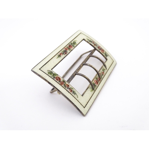 575 - A silver buckle with white guilloche enamel decoration and floral detail. Hallmarked Birmingham 1912... 