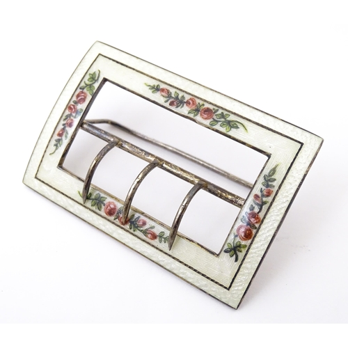 575 - A silver buckle with white guilloche enamel decoration and floral detail. Hallmarked Birmingham 1912... 