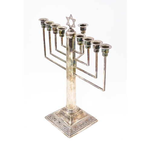 580 - Judaica : A silver Hanukkah Menorah with 9 branches and surmounted by Star of David. Hallmarked Lond... 