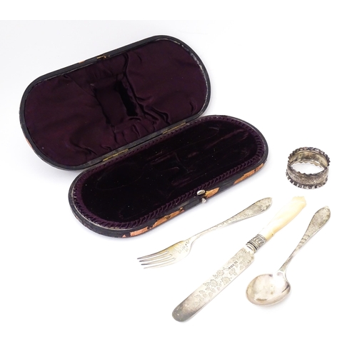 594 - A cased silver christening set comprising knife, fork and spoon with engraved foliate detail hallmar... 