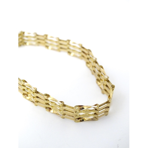 689 - A gold bracelet with padlock formed clasp.