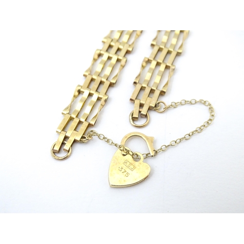 689 - A gold bracelet with padlock formed clasp.