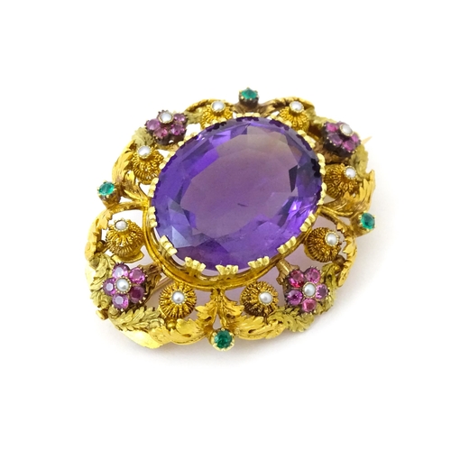 693 - An impressive Victorian brooch set with large central amethyst within a floral and foliate mount set... 