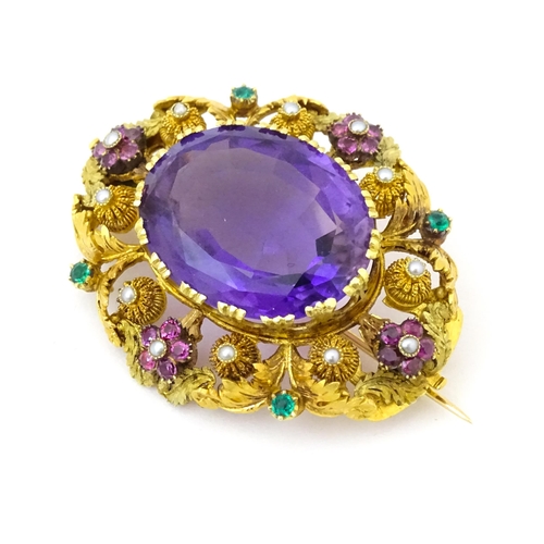 693 - An impressive Victorian brooch set with large central amethyst within a floral and foliate mount set... 