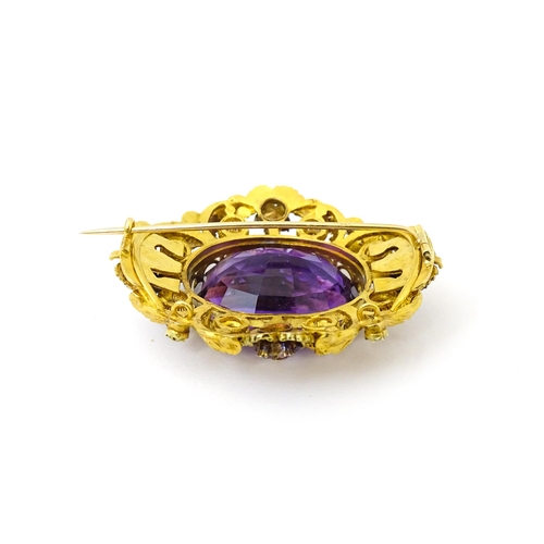 693 - An impressive Victorian brooch set with large central amethyst within a floral and foliate mount set... 