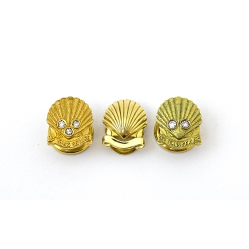 694 - Shell long service awards : A French gold stud / button of shell form by Cartier Paris. Marked verso... 