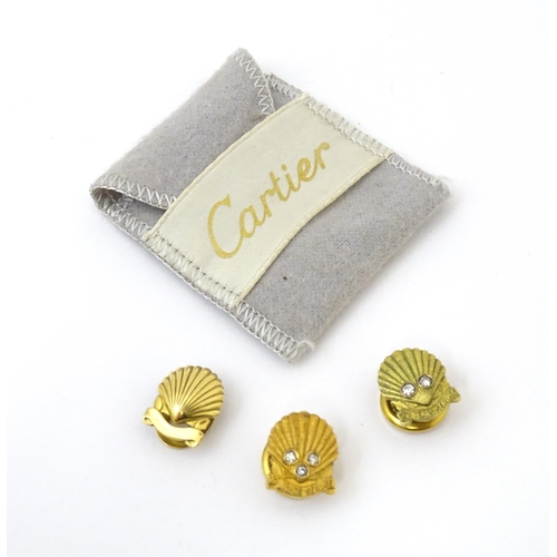 694 - Shell long service awards : A French gold stud / button of shell form by Cartier Paris. Marked verso... 