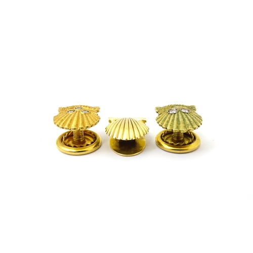 694 - Shell long service awards : A French gold stud / button of shell form by Cartier Paris. Marked verso... 