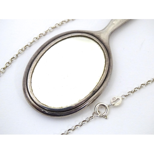 696 - A silver necklace with pendant formed as  silver miniature / dolls  hand mirror. hallmarked Birmingh... 