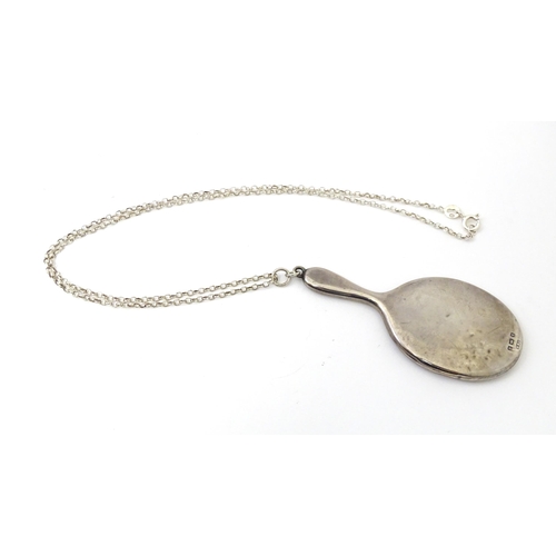 696 - A silver necklace with pendant formed as  silver miniature / dolls  hand mirror. hallmarked Birmingh... 