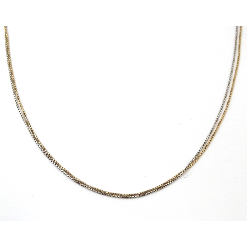 697 - A 9ct gold chain, together with another of white and yellow gold. Both approx 18