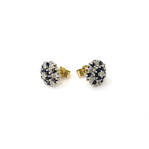 698 - A pair of 9ct gold stud earrings set with diamond and spinel cluster