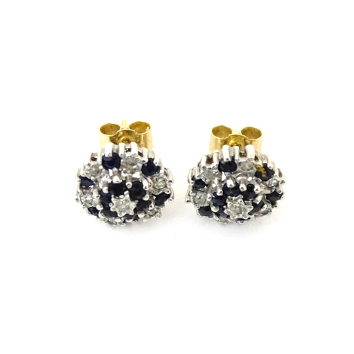 698 - A pair of 9ct gold stud earrings set with diamond and spinel cluster