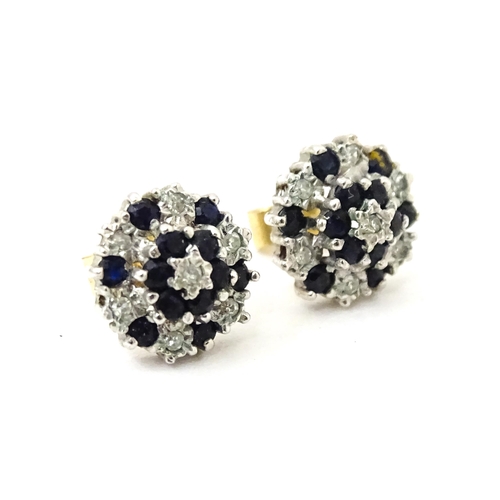 698 - A pair of 9ct gold stud earrings set with diamond and spinel cluster