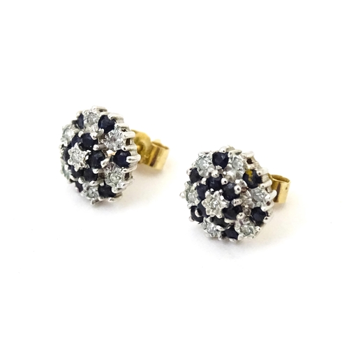 698 - A pair of 9ct gold stud earrings set with diamond and spinel cluster