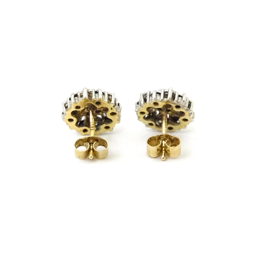 698 - A pair of 9ct gold stud earrings set with diamond and spinel cluster