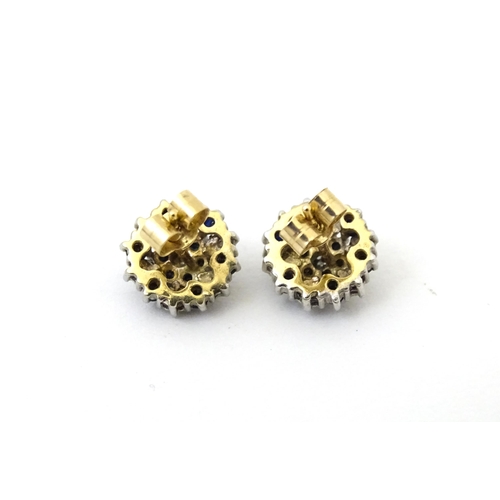 698 - A pair of 9ct gold stud earrings set with diamond and spinel cluster