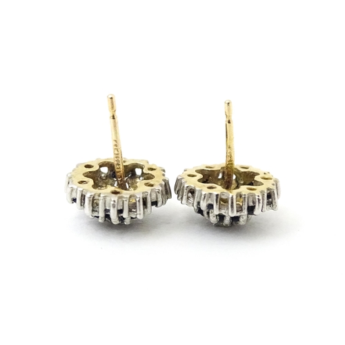 698 - A pair of 9ct gold stud earrings set with diamond and spinel cluster